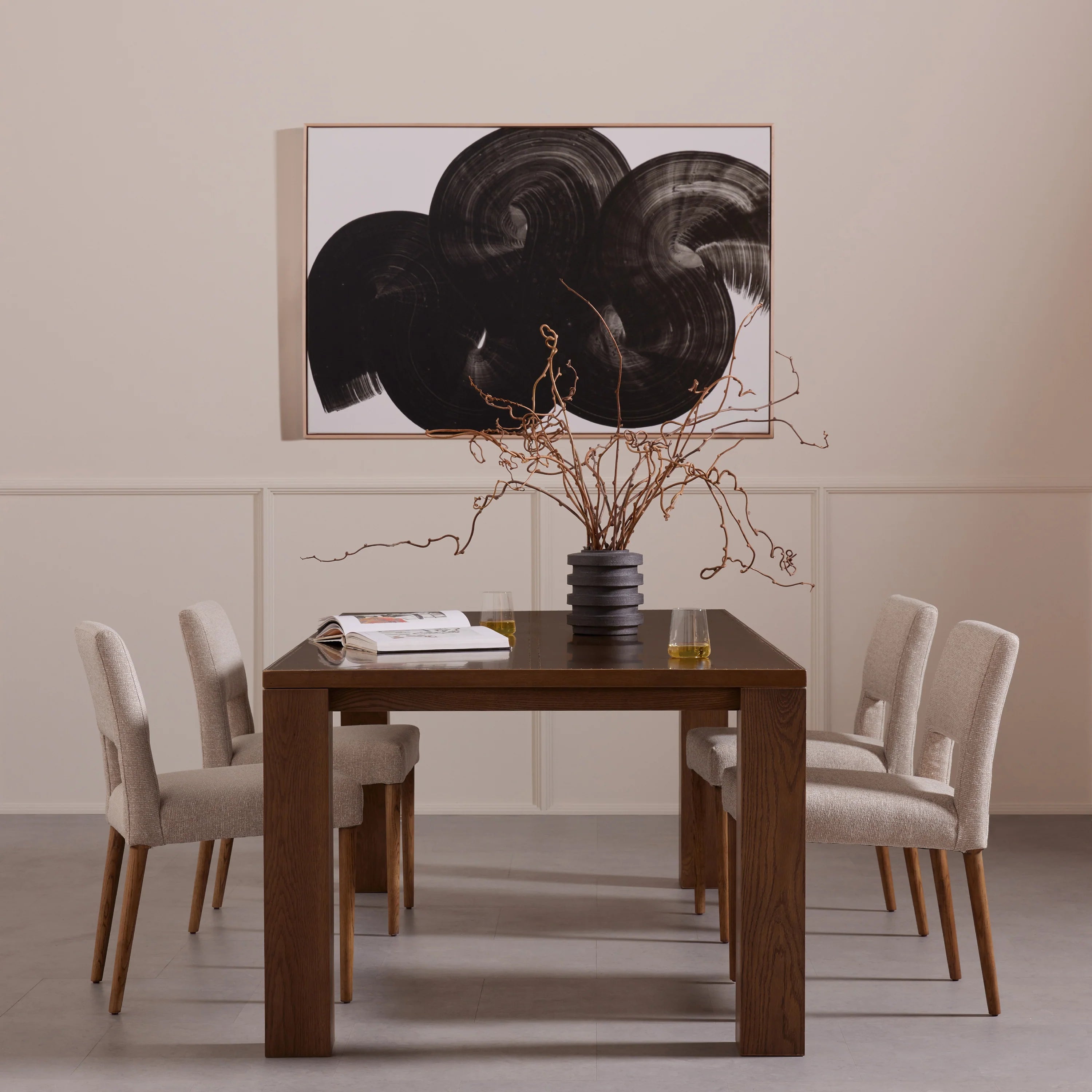 Armless dining chair set with light camel upholstery and wooden legs at a dining table.
