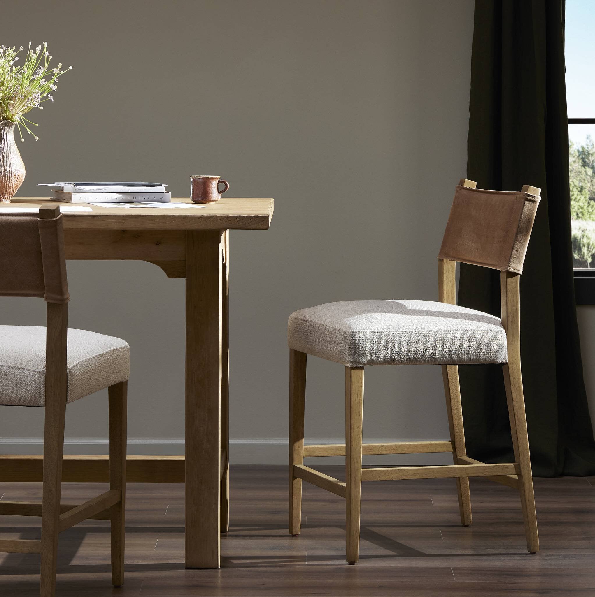 Cream padded counter stool with tan leather-look back and wooden base