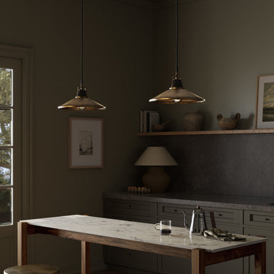 Dining room with marble table, Novak 10-inch hand-hammered antique brass pendant light with perforated metal edge detail , and shelves with decor items