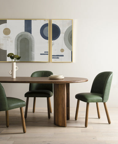 Dining scene Paden Dining Table in Seasoned Brown Acacia with crescent-shaped legs and an oval tabletop