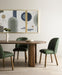 Dining scene Paden Dining Table in Seasoned Brown Acacia with crescent-shaped legs and an oval tabletop