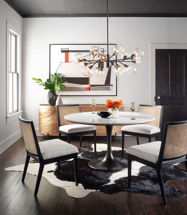 Modern dining room with round table, Primary Retro-modern armless dining chair with vertical cane weaving and contract-grade upholstery for upscale restaurants, and decorative elements