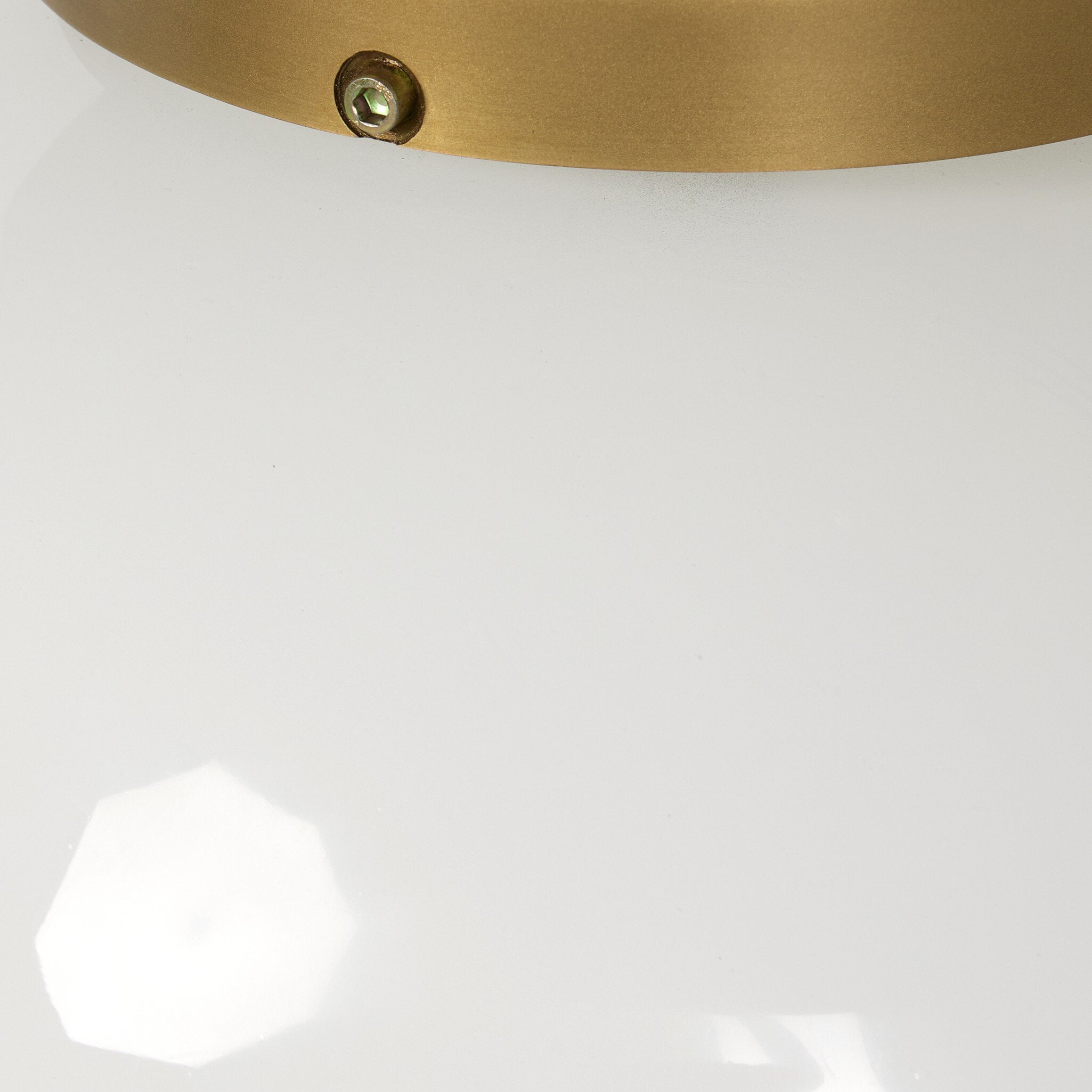 Evelie soft modern pendant light with hand-blown white glass globe and antique brass fixture chain detailed