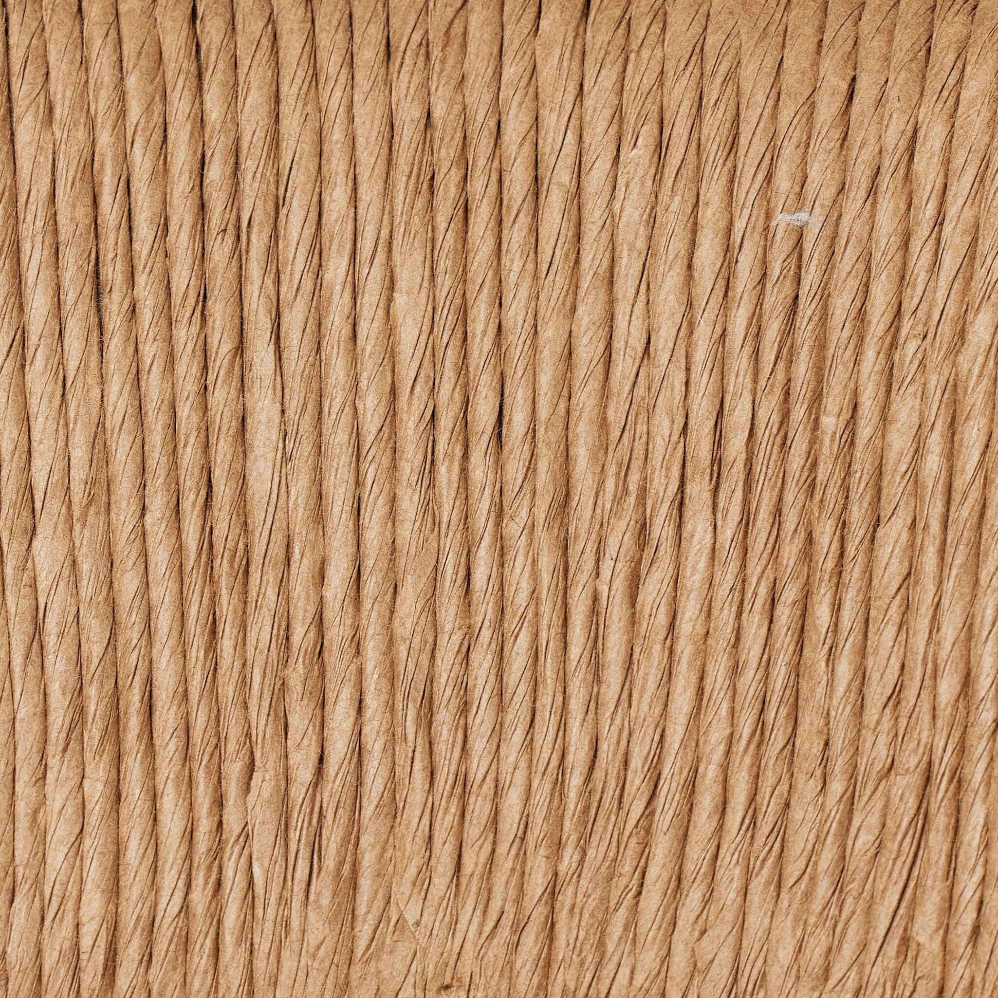 Close-up of tan woven rope texture on a bar stool backrest