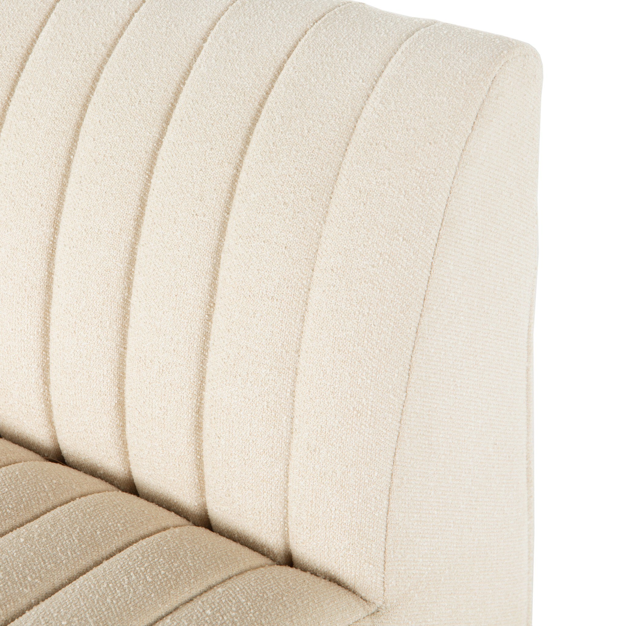 Close-up of a beige upholstered chair with a textured fabric.