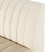 Close-up of a beige upholstered chair with a textured fabric.