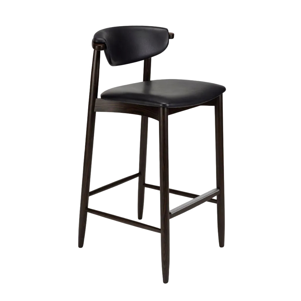 Bar stool with black upholstered seat, dark wood legs and frame, angled footrest bar