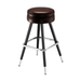 Brown upholstered bar stool with round seat, chrome footrest, black tapered legs
