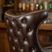 Fudge Brown Close-up of the Prescott stool’s intricate button tufting and sturdily crafted frame designed for Western-inspired luxury