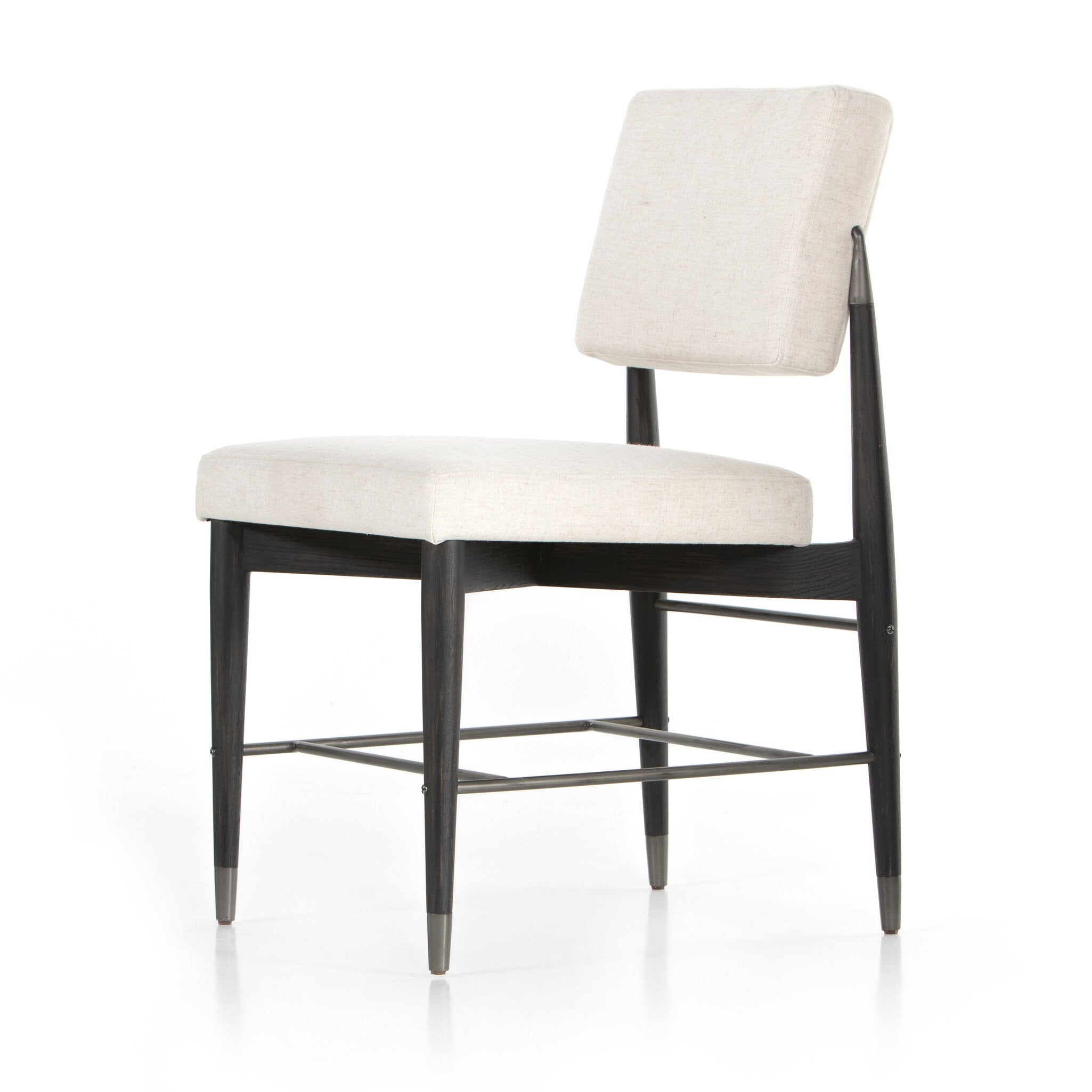 Angled Anton Dining Chair in Savile Flax performance fabric with black tapered oak legs and industrial iron-dipped caps