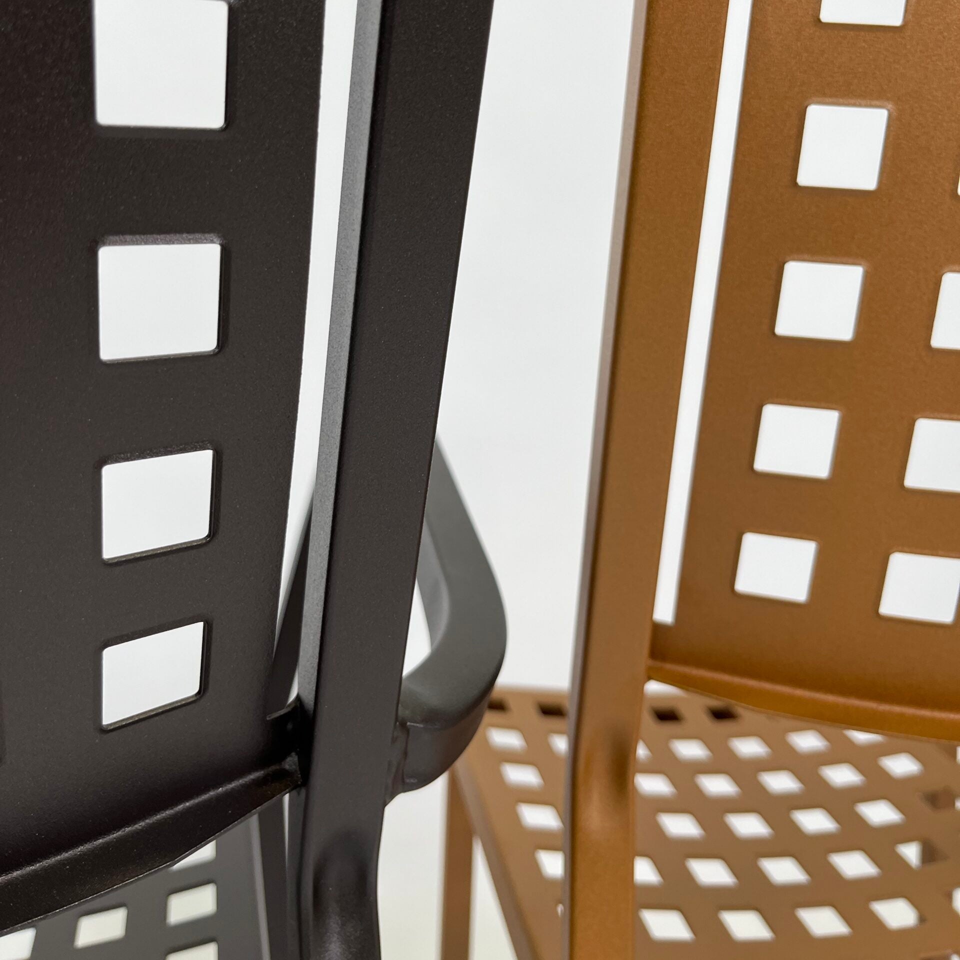 Zurich arm chair close-up: perforated back panel, curved armrest, slotted seat