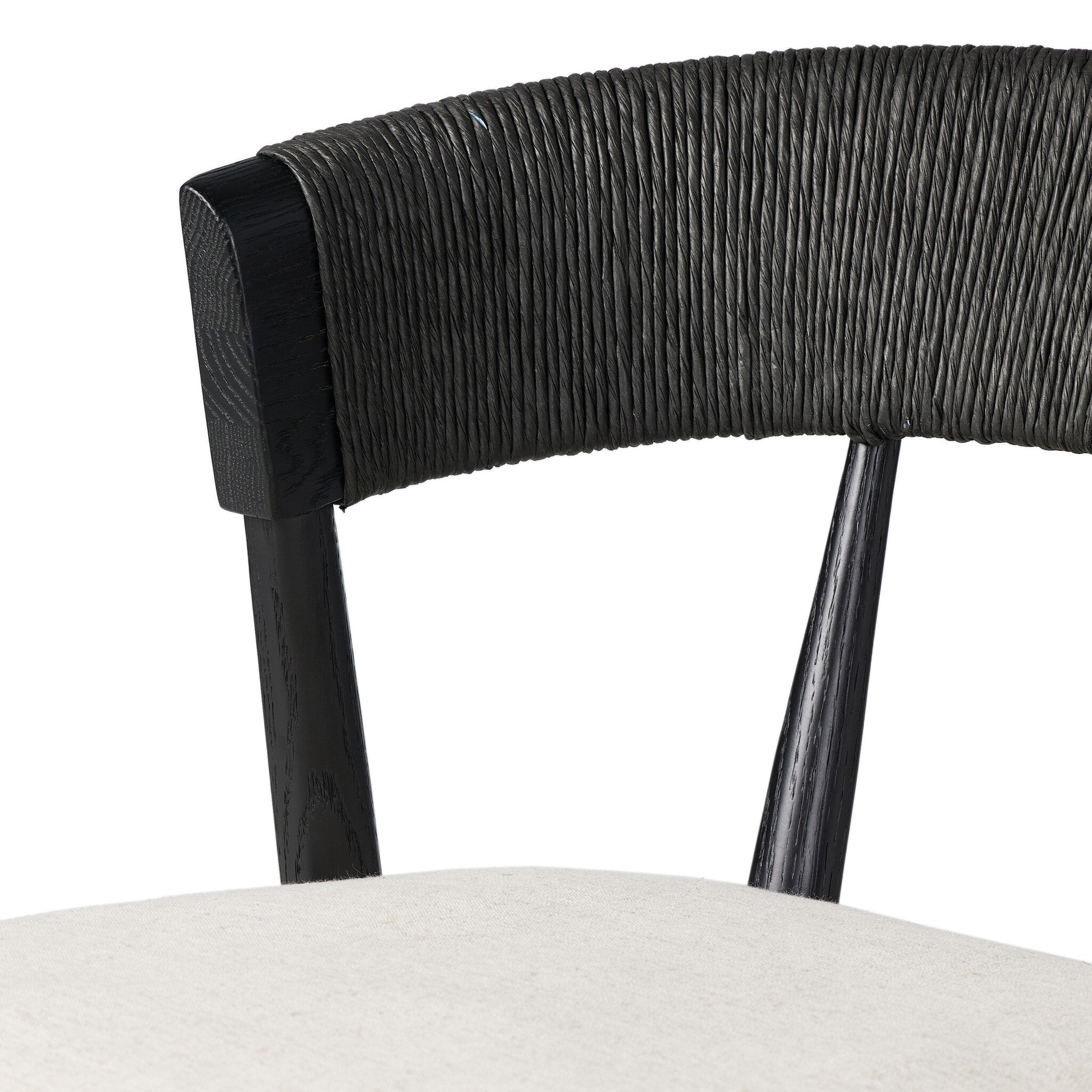 Bar stool close-up of black woven back and cream upholstered seat