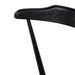 Black oak counter stool backrest detail with smooth rounded edge, dark woodgrain close-up