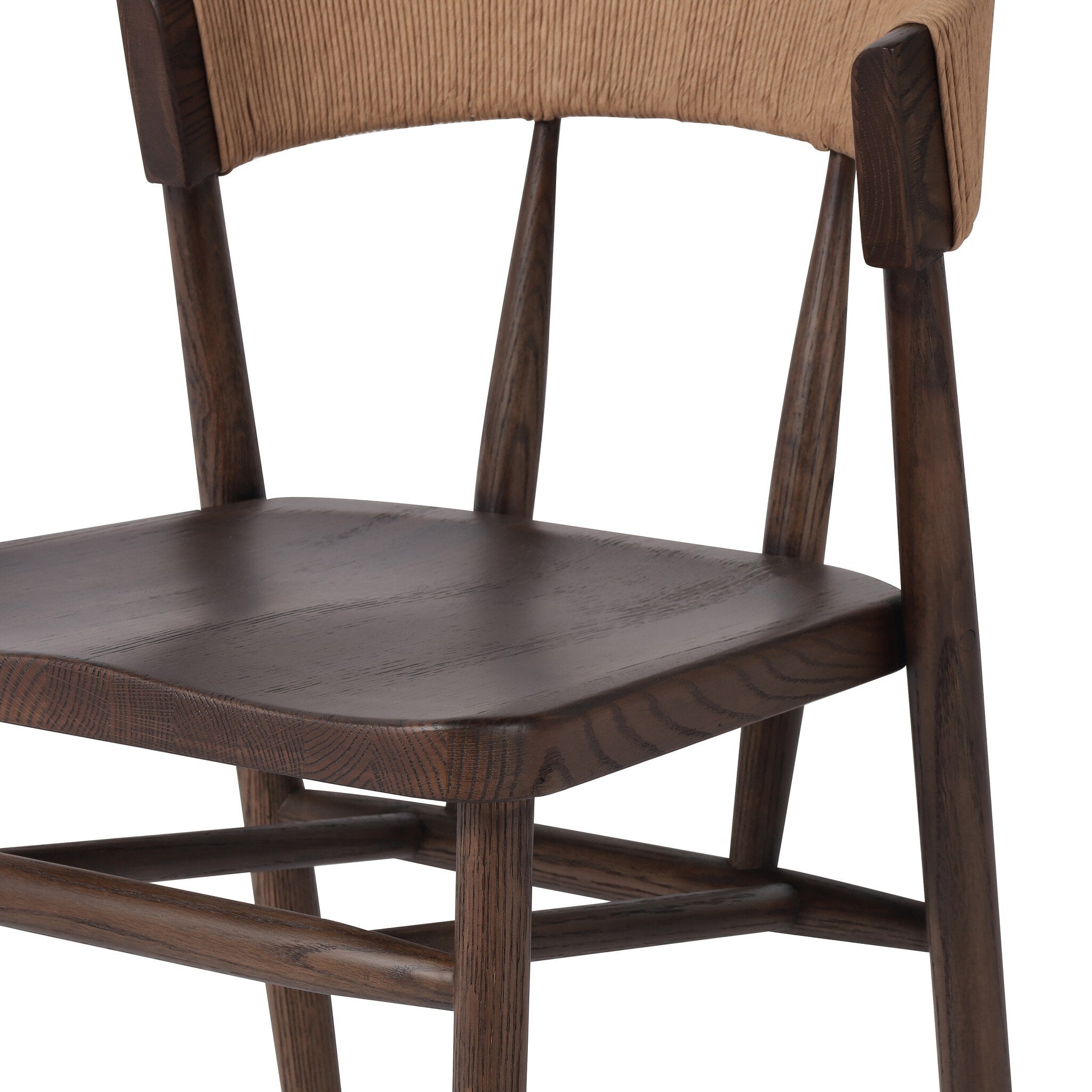 Inner detail A solid oak dining chair with a paper rush wrapped detail on the back, tapered legs, and a dark finish.