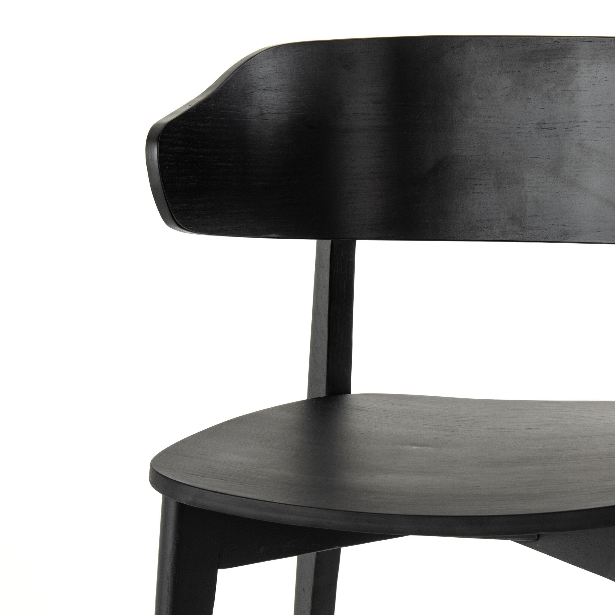 Black armless dining chair close-up of backrest and seat with tapered leg