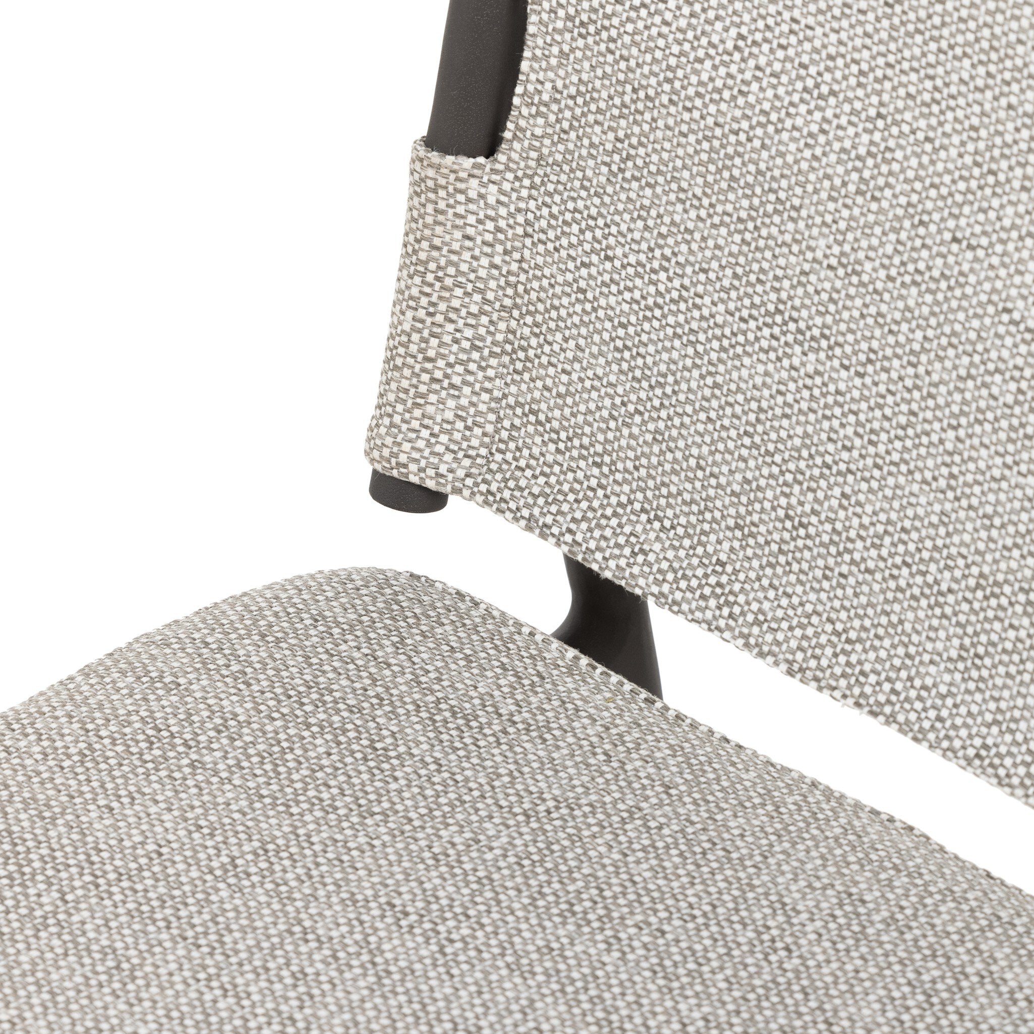 Inner detail Miller outdoor performance dining chair with a light taupe fabric cushion, wrap detail, and a crossed bronze aluminum frame.