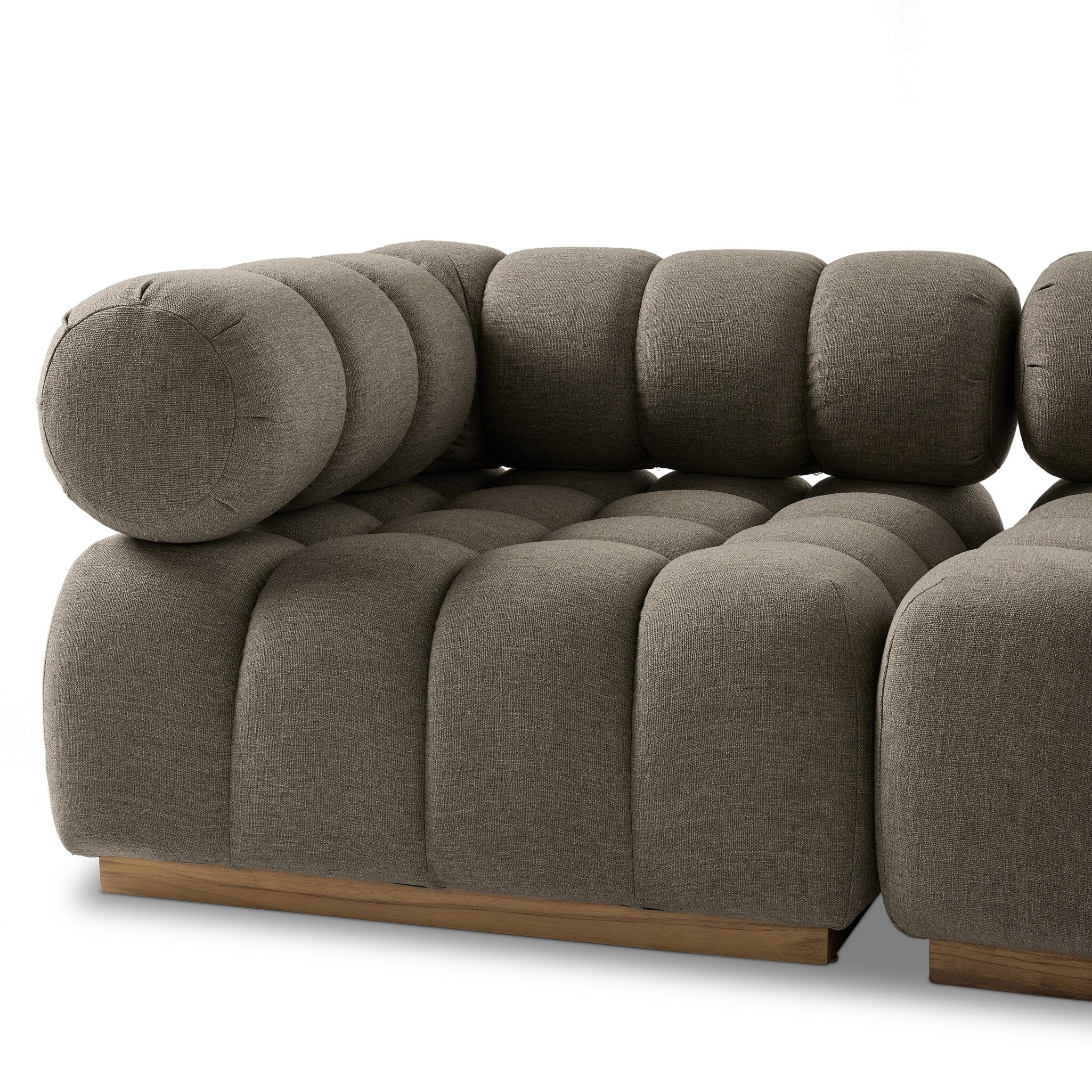 Outdoor sectional sofa in Alessi Fawn with rounded bolster pillows and deep seat cushions