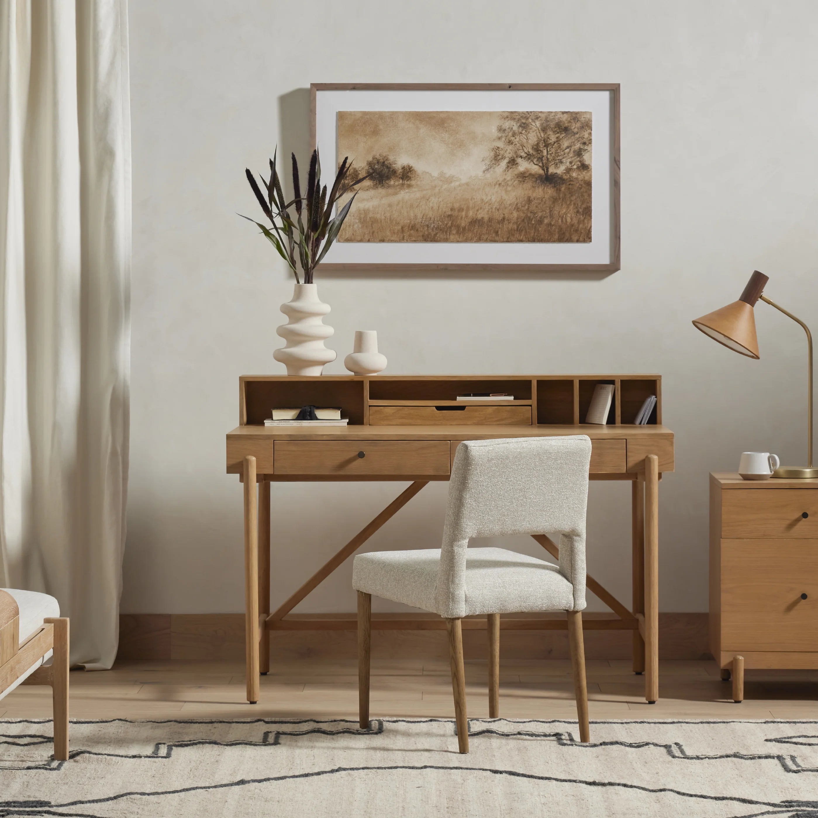 Armless dining chair with light camel upholstered seat and back, wooden legs in room setting.