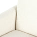 Close-up of a textured beige and white sofa corner on a white background