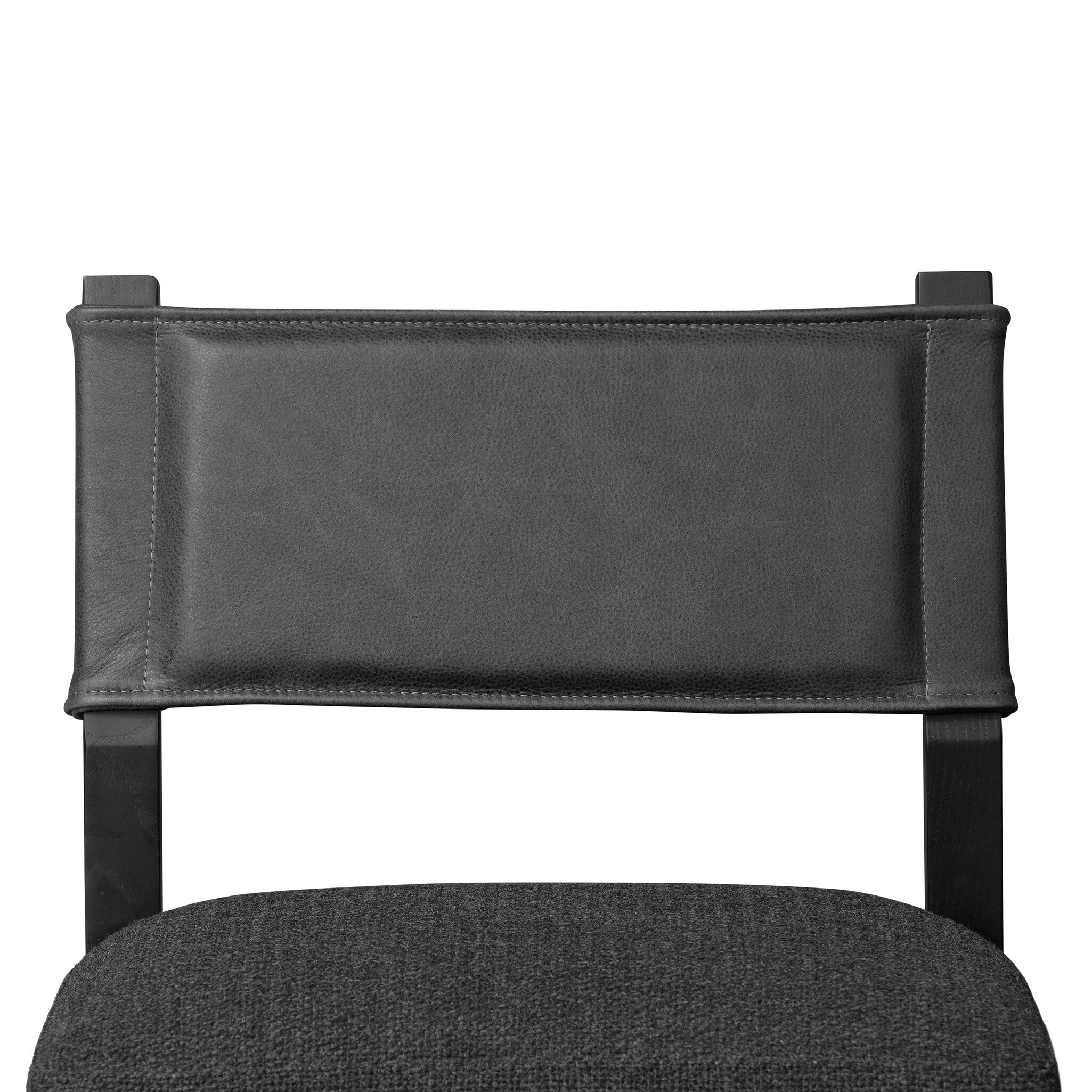 Armless dining chair with dark upholstered back and gray fabric seat cushion, close-up