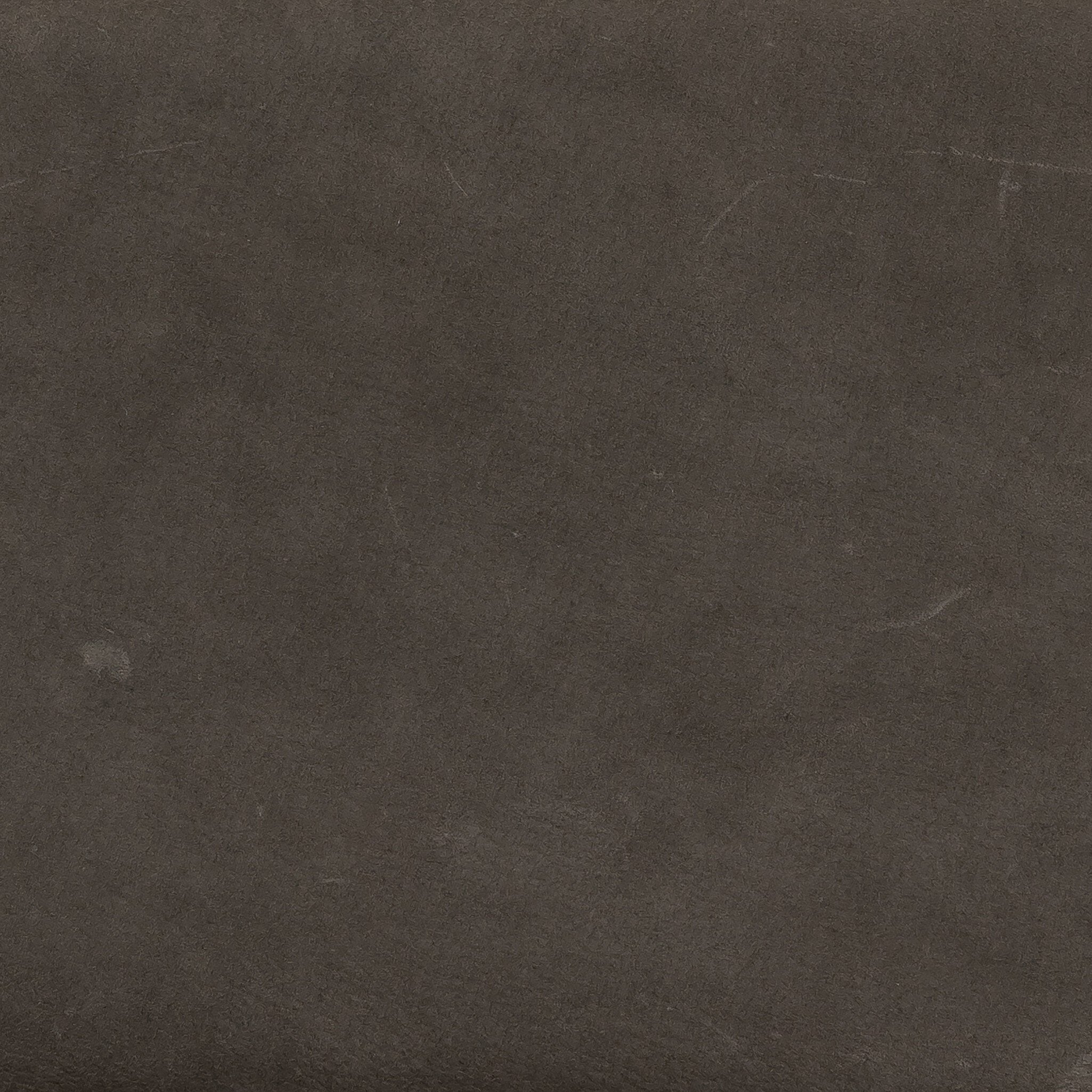 Armless dining chair backrest close-up in dark leather-look fabric texture