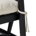 Bar stool with light upholstered seat edge and black wooden leg with tied trim