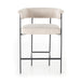 Upholstered counter stool with light camel fabric seat and curved backrest; black metal legs