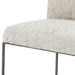 Light gray upholstered bar stool seat edge with dark metal arm and frame