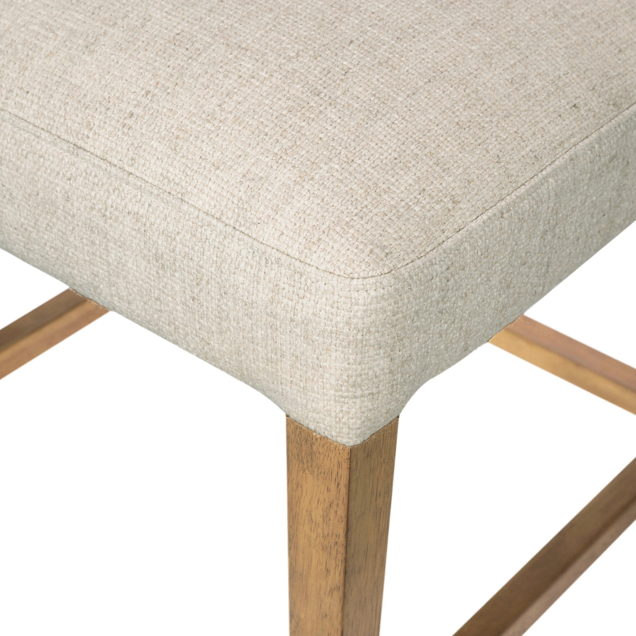 Cream upholstered seat edge on wooden legs for counter stool