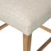Cream upholstered seat edge on wooden legs for counter stool