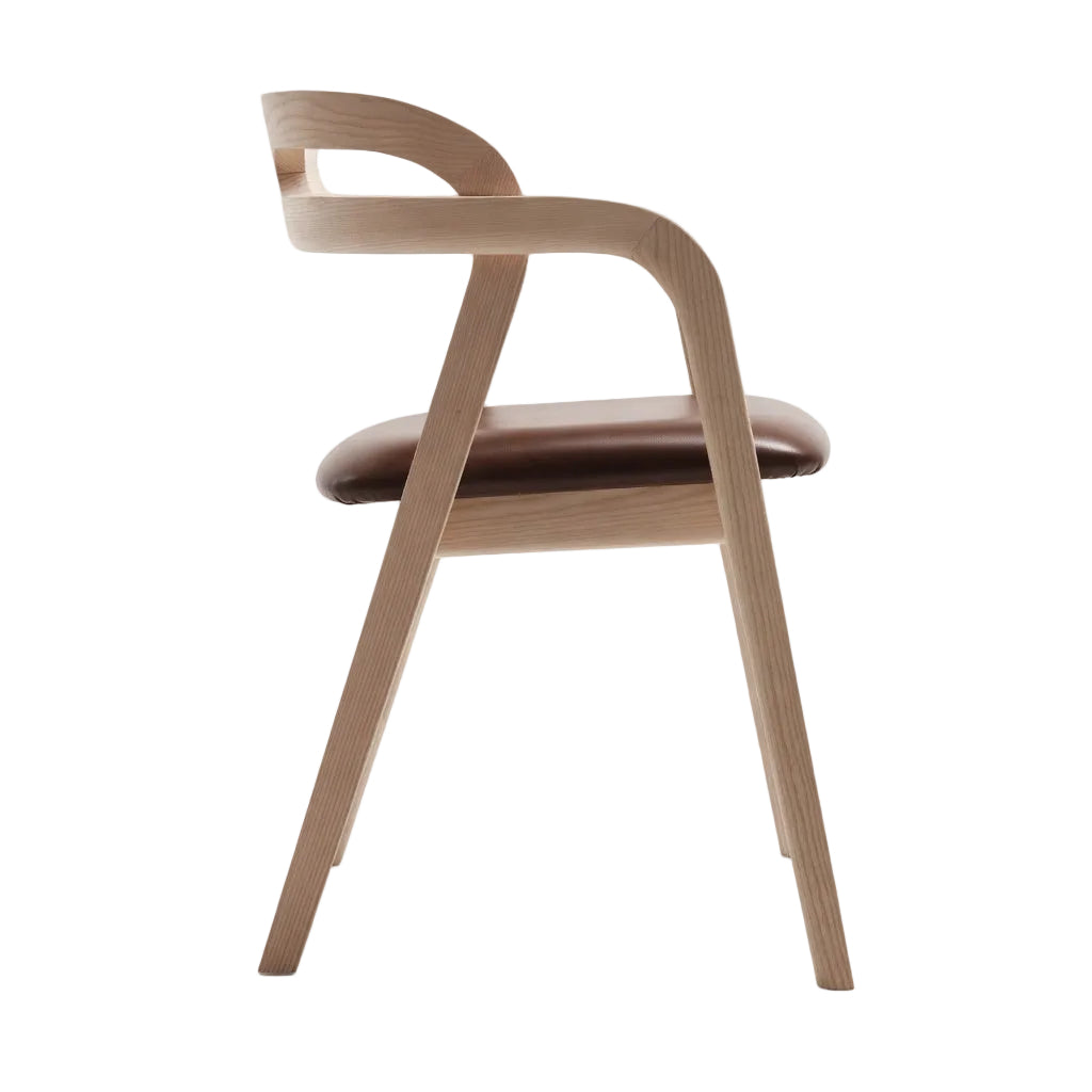 Arm chair with light wood frame and dark brown padded seat, curved armrests, angled legs