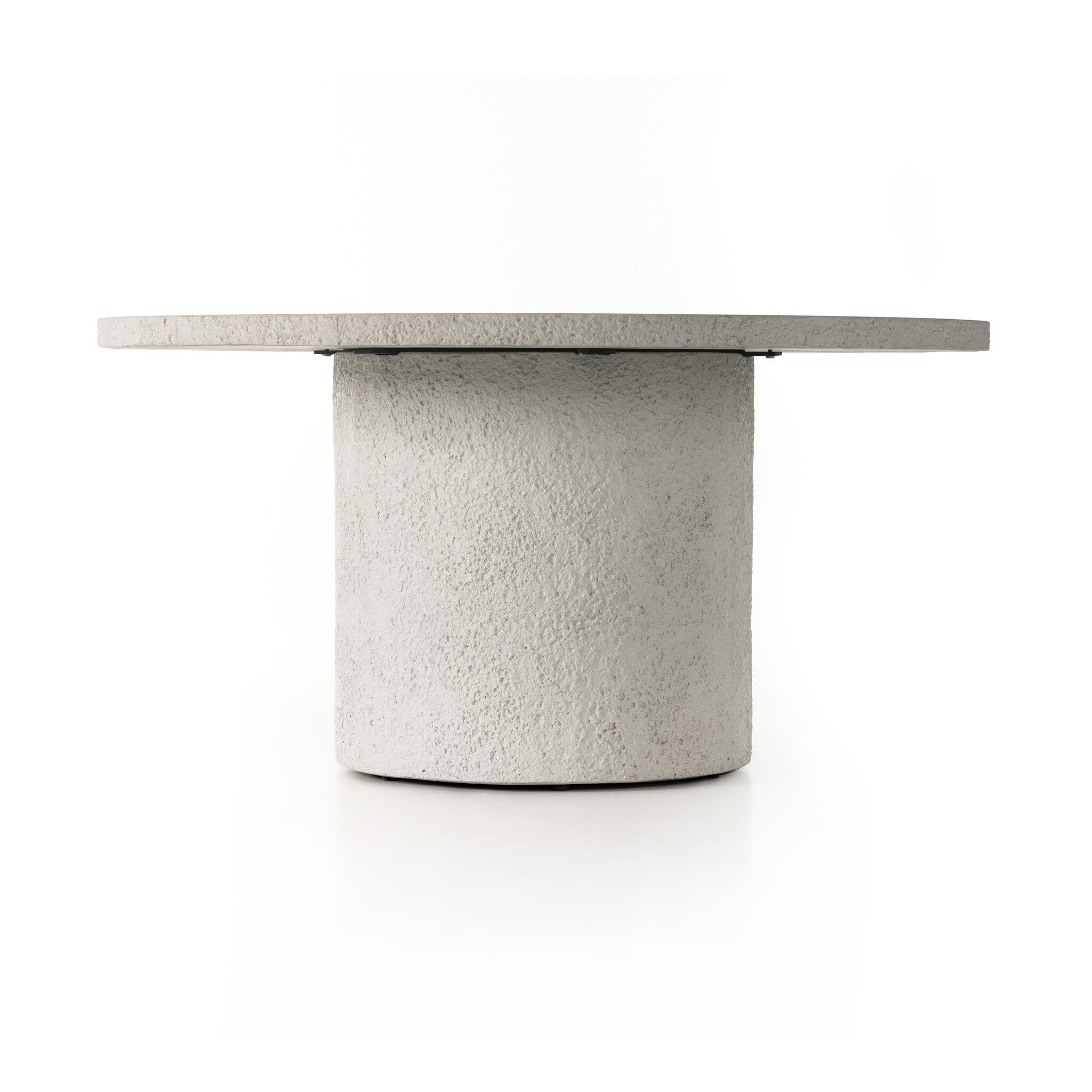 Otero Outdoor Round Dining Table in Matte Stone solid concrete with raw textured edging.