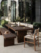 Outdoor dining area with wooden table and Lomas Dining Chairs in Vintage White woven wicker with a tapered natural teak frame in a modern setting