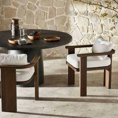 Outdoor Hospitality Scene Tahana Outdoor Dining Armchair with three-leg wood frame and Alessi Linen cushions