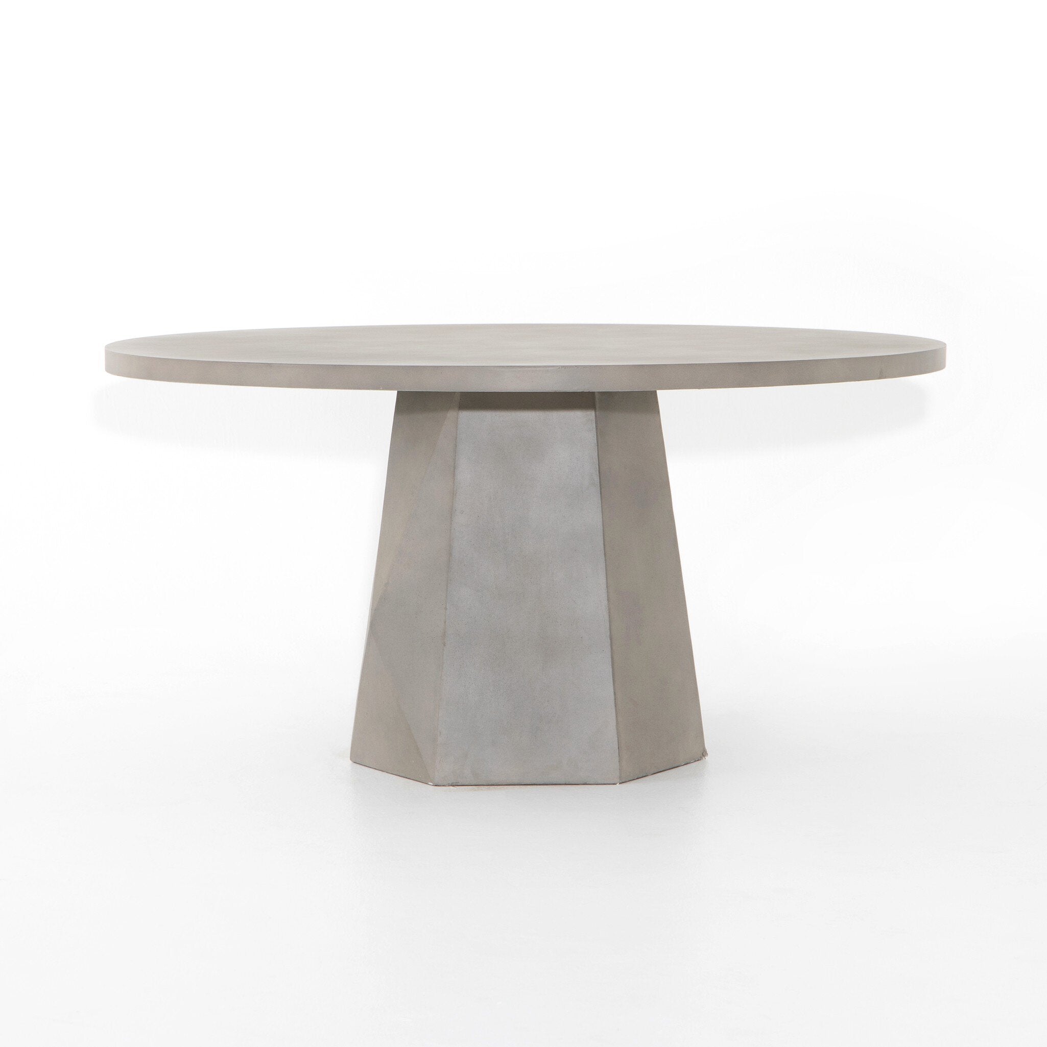Outdoor Dining Table with a round white concrete top and tapered pedestal base