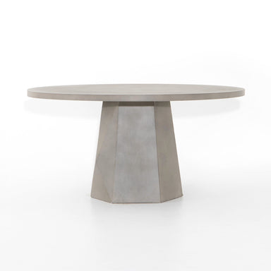 Outdoor Dining Table with a round white concrete top and tapered pedestal base