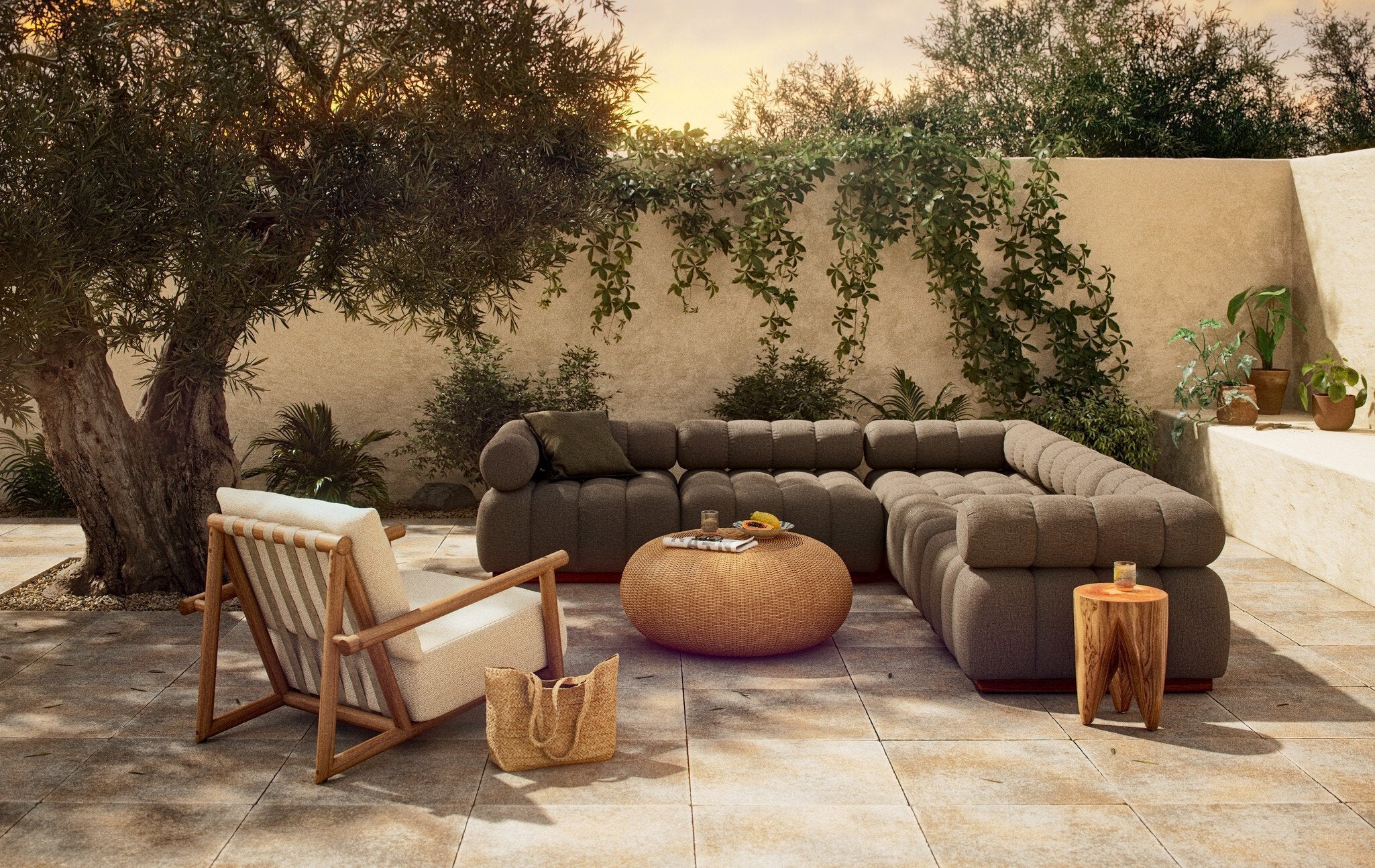 Outdoor patio with a A five-piece sectional sofa with a teak wood base and upholstered in a brown fabric, featuring a modular design, armchair, and coffee table in a garden setting.