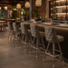 Outer tufted bar stool showcasing a 360-degree textured design and modern architectural profile for luxury hospitality use