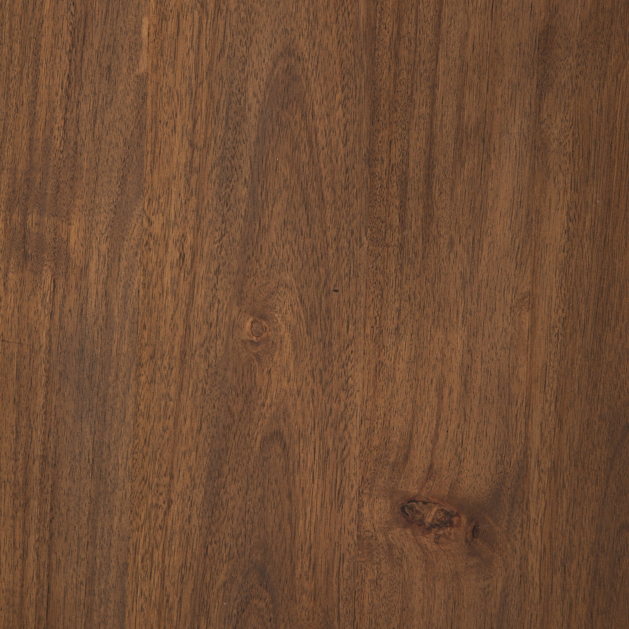 Close-up of a wooden surface with a rich brown color and visible grain.