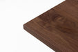 Walnut tabletop top view with rich wood grain and beveled side edge