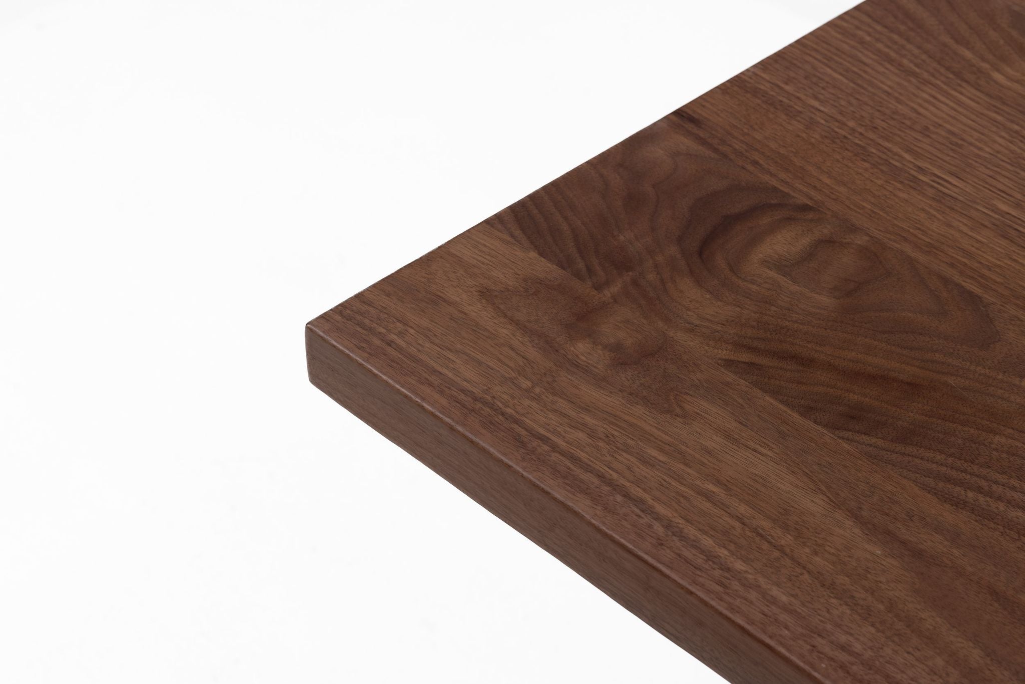Walnut tabletop top view with rich wood grain and beveled side edge