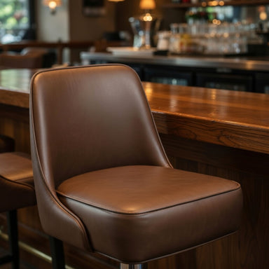 Porcini Fudge Brown Ellington Bolted Floor-Mounted Counter Stool featuring a plush, upholstered seat in restaurant