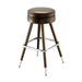 Tan upholstered bar stool with round padded seat, chrome footrest, brass legs