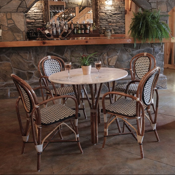 Set of four side chairs with brown wood frames and woven black-and-white seats