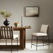 Counter stool with beige fabric seat and backrest on black metal frame, in dining setting