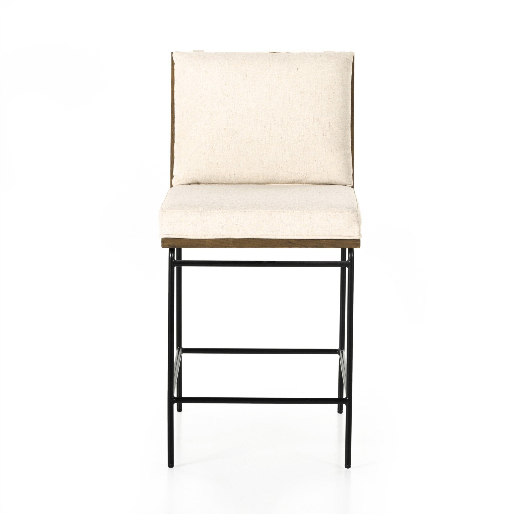 Counter stool with cream fabric seat and backrest, black metal frame, and footrest