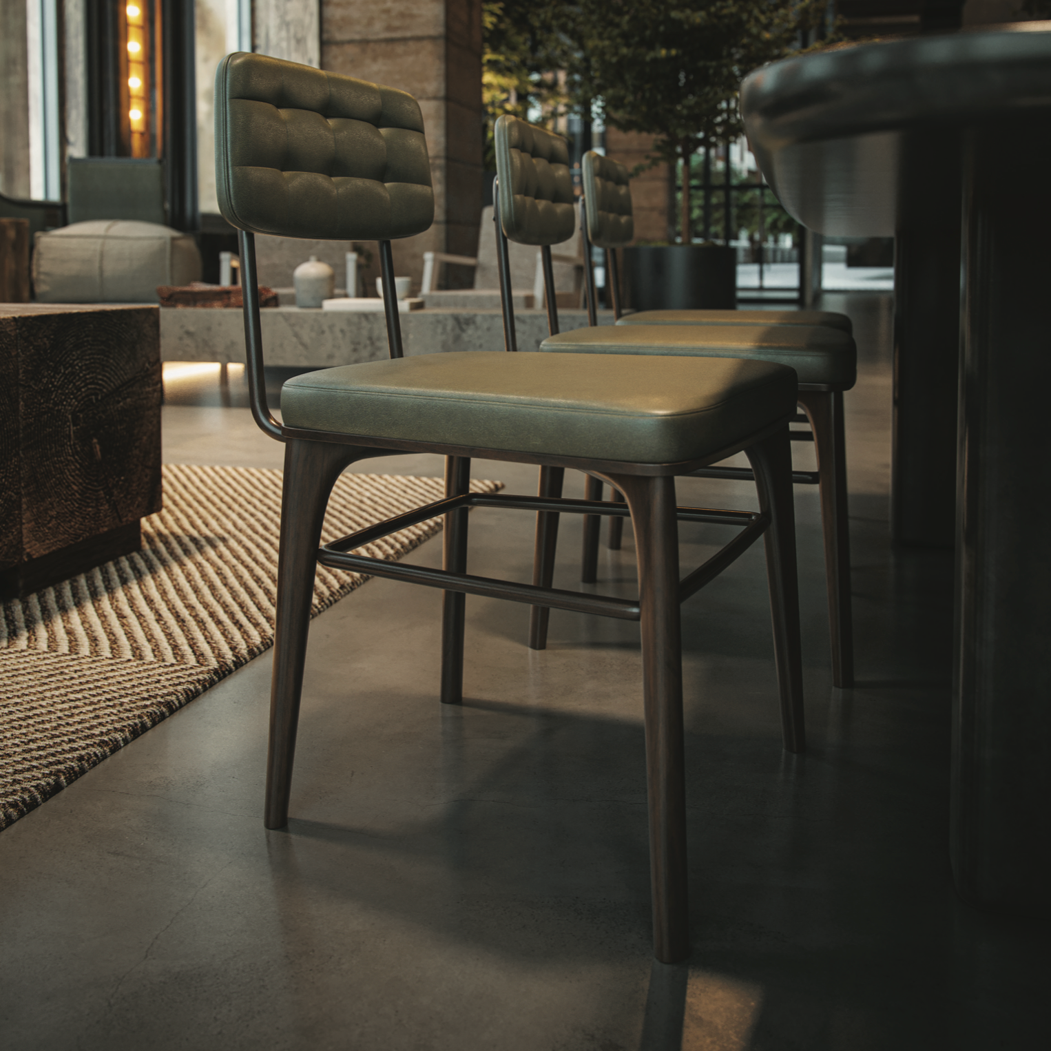 Dark gray upholstered side chair with tufted back and metal footrest frame