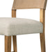 Cream upholstered seat and wooden legs on tan leather-look counter stool