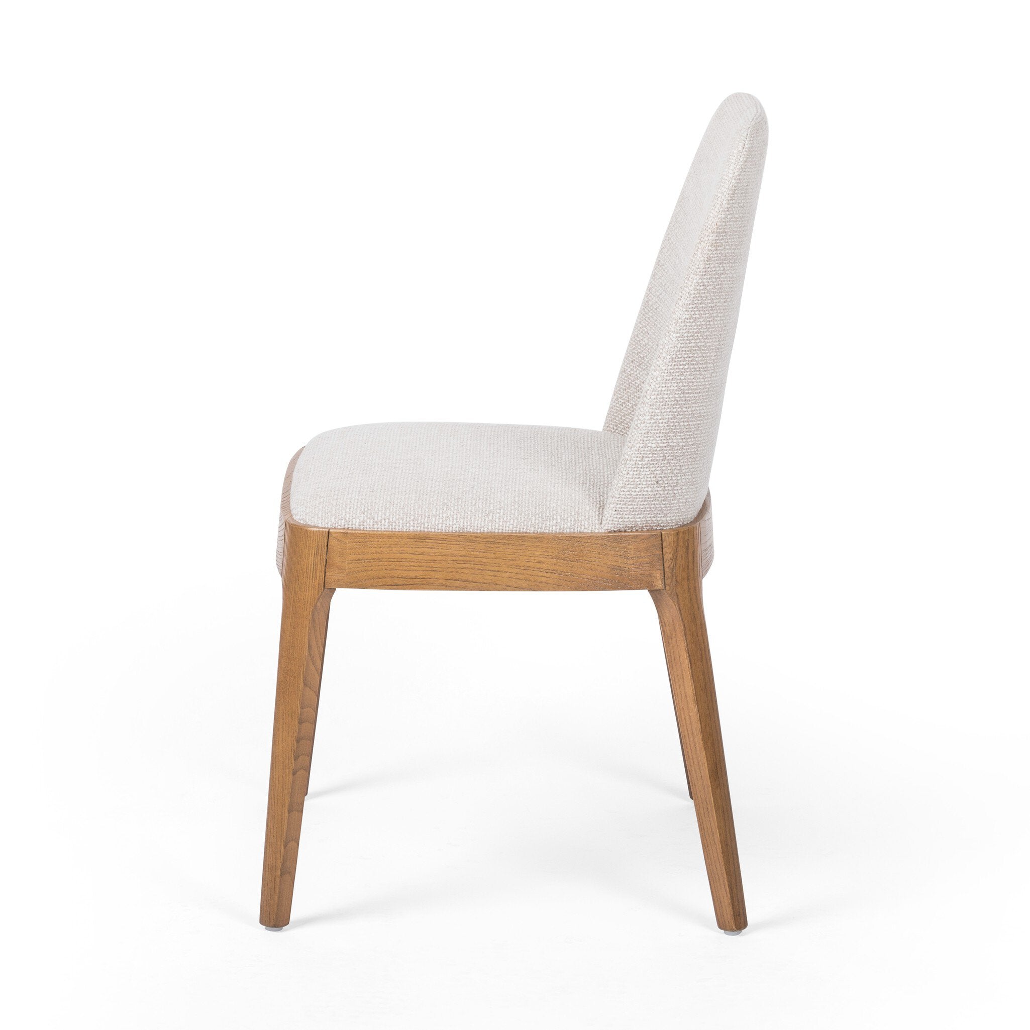 Side Bryce Armless Dining Chair in light honey solid nettlewood with high-performance upholstered seat, transitional hospitality seating