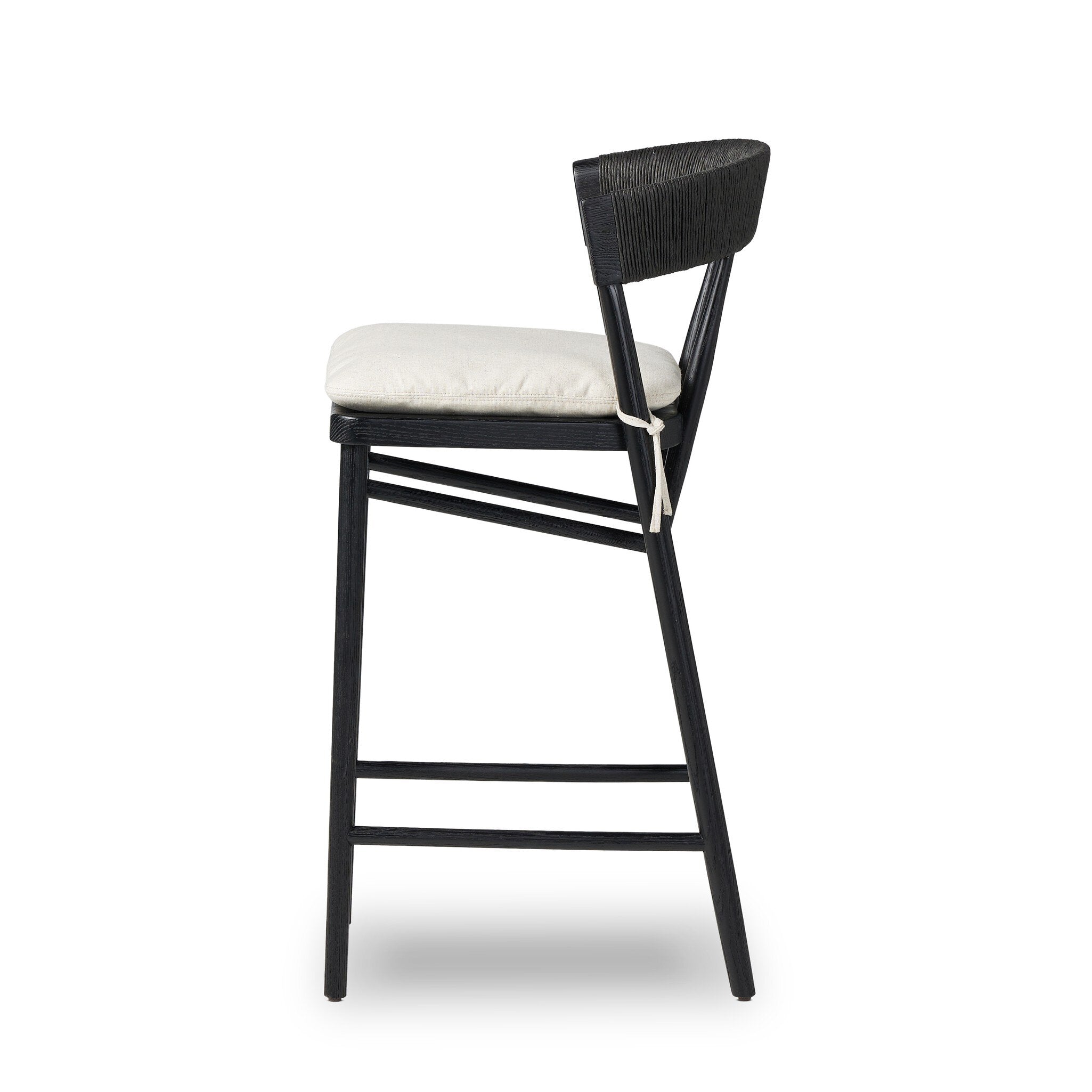 Bar stool side view with black frame, rounded back, and cream padded seat